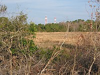 large towers that are on opposite sides of 33 on the top of a hill that was once covered with microwave links