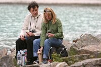 cute couple enjoying a picnic with an interested critter