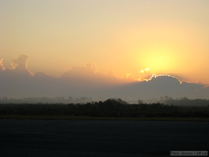 light ground fog hangs low as the sun rises over Valkyria airport