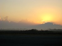light ground fog hangs low as the sun rises over Valkyria airport