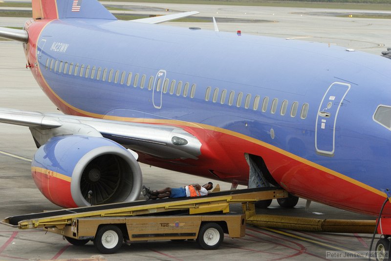 Southwest ramp worker taking a break while waiting for bags to arrive.