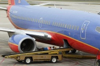 Southwest ramp worker taking a break while waiting for bags to arrive.