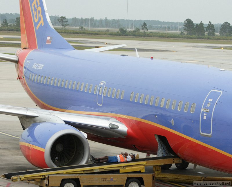 Southwest ramp worker taking a break while waiting for bags to arrive.