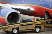 Southwest ramp worker taking a break while waiting for bags to arrive.