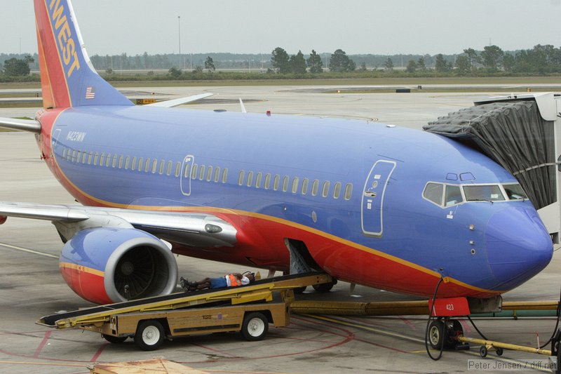 Southwest ramp worker taking a break while waiting for bags to arrive.