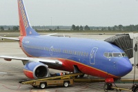 Southwest ramp worker taking a break while waiting for bags to arrive.