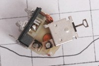 the disassembled relay showing evidence of arcing on the contacts