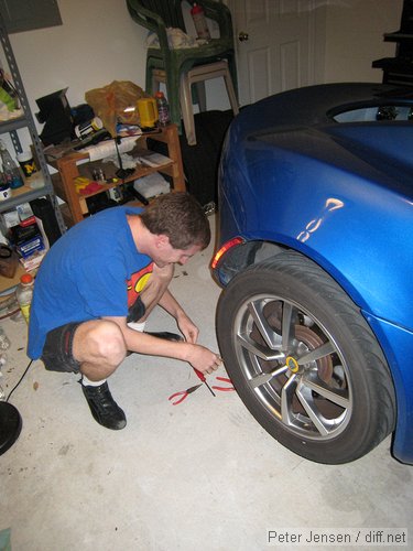 trying to pull out a nail to plug it