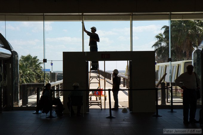 folks working at MCO on the tram doors