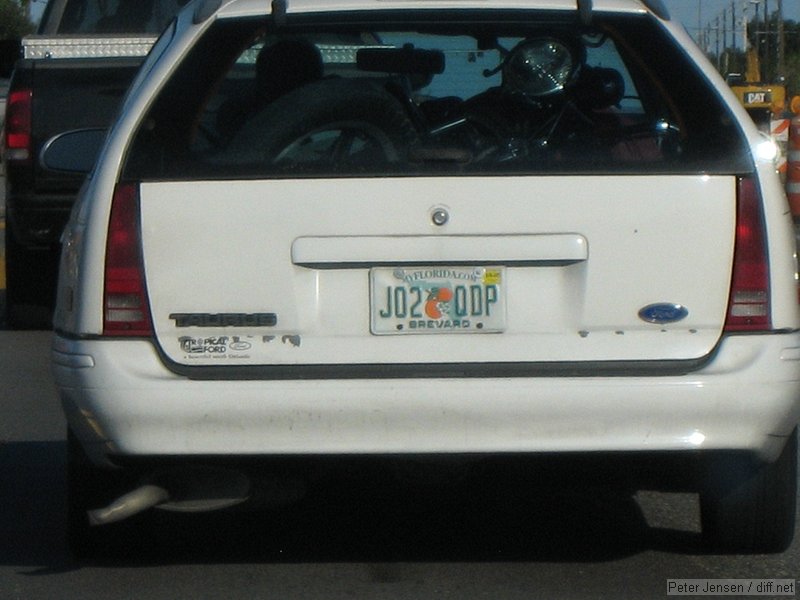 Taurus station wagon with a motorcycle thrown in the back