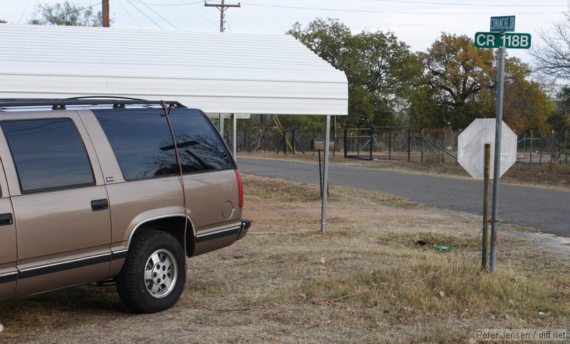 this seems like a mean prank - the heavy duty rope tied to the roof rack and street sign.