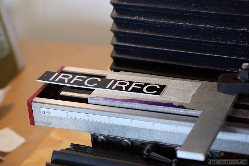 carpet tape to hold it down and blank nameplate material from a sign and trophy store. My CNC mill had just finished routing the one on the right.