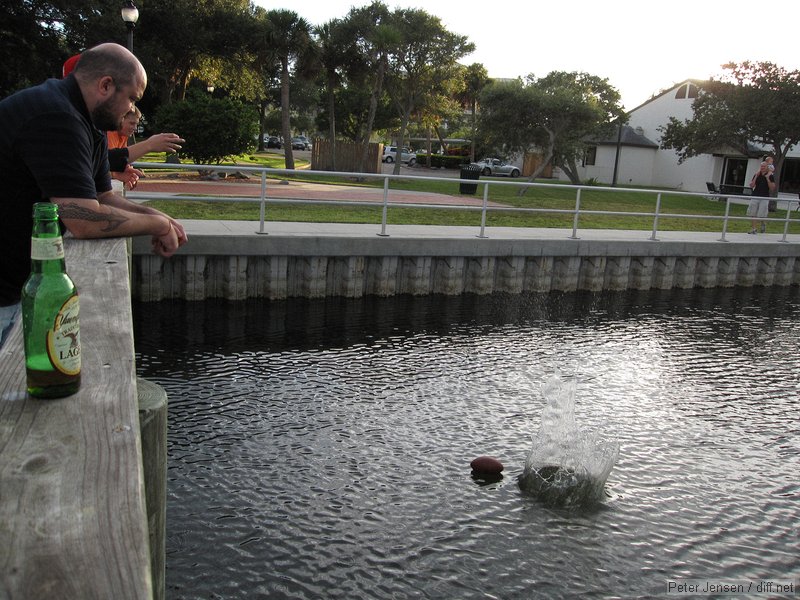 attempting to coax the footbal closwer with a rock