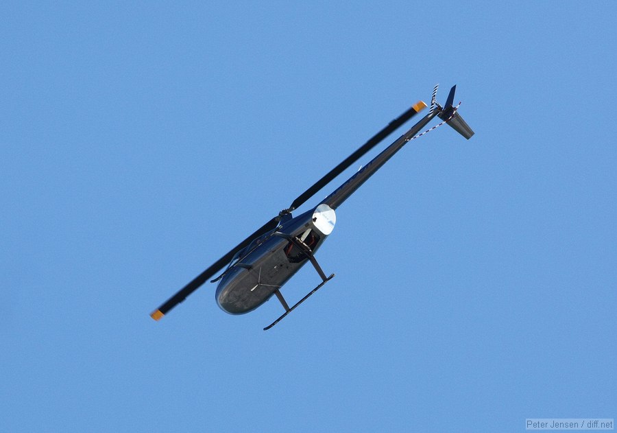 R44 cruising down the beach