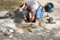 nice guy clearing black plastic from the septic pump inlet