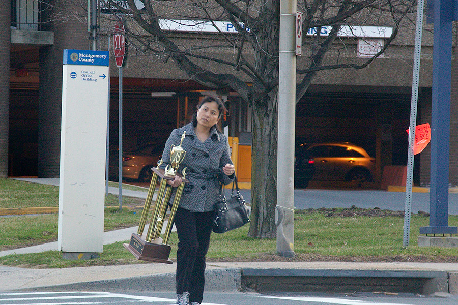 just your standard woman walking down the street with a giant trophy