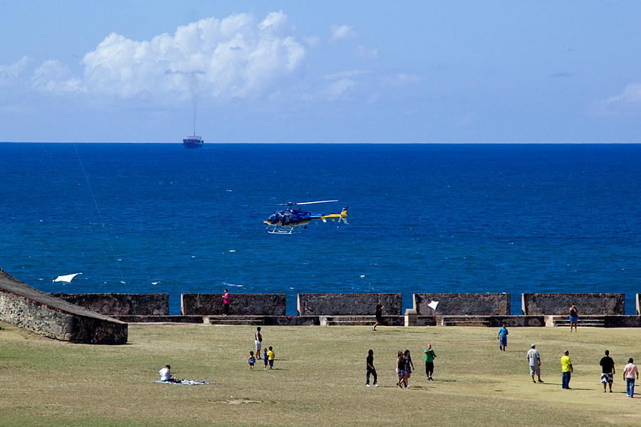helicopter patrol over El Morro with a ship coming in and several kites up.