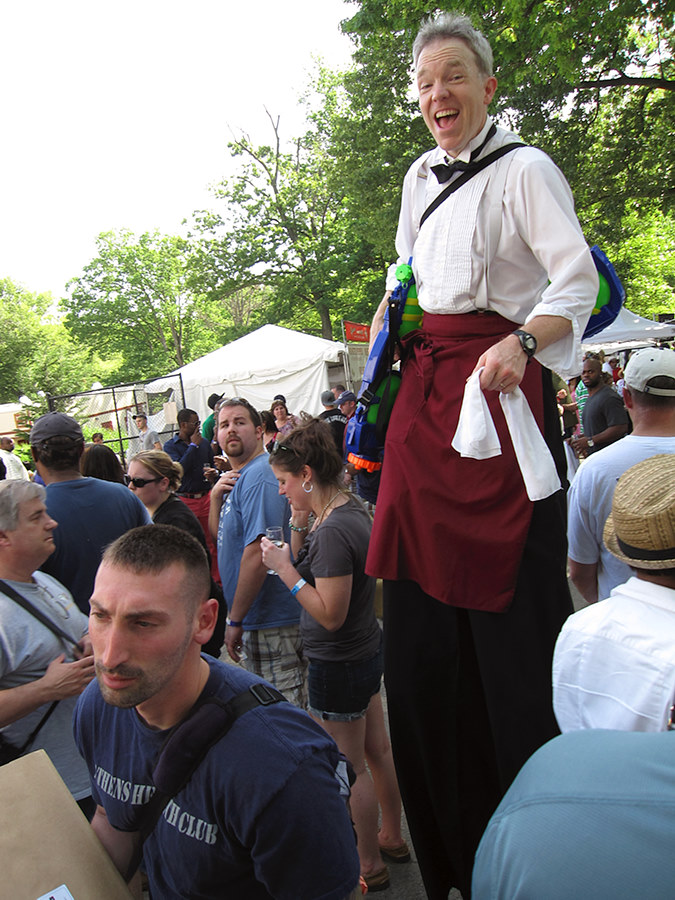 awesome dude on stilts with a super soaker