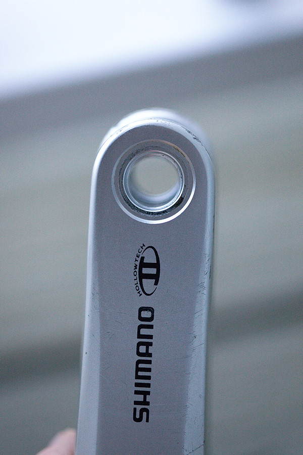 view through the left side crank's pedal hole toward the longer right-side crank