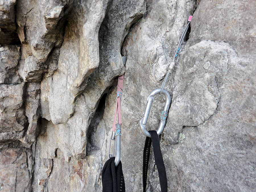 pink tri-cam threaded through a gap in the rock