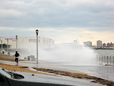 waves crash ashore at a park alone the Belt Parkway