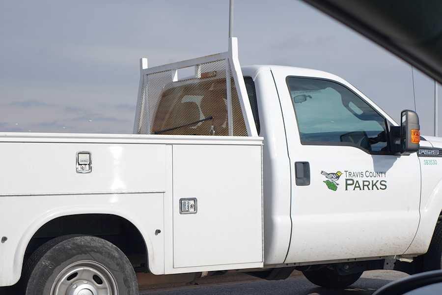 Travis County Parks vehicle with a handcuff on the window guard.