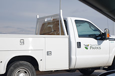 Travis County Parks vehicle with a handcuff on the window guard.