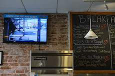 watch for the bus here - innovative use of CCTV at a coffee shop in front of a bus stop