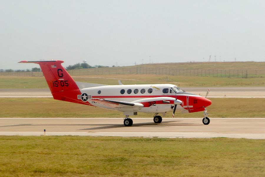 Navy plane being followed closely by a fire truck