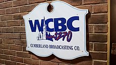 downtown office sign for the AM station with transmitters up on the hill