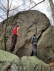 scoping the wide crack/ramp on the trailside boulder