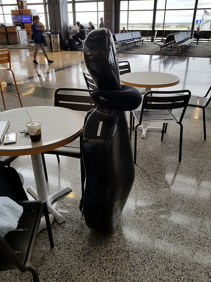 this cellist provides a neck pillow for her instrument