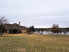 view of the house from across the lake/river