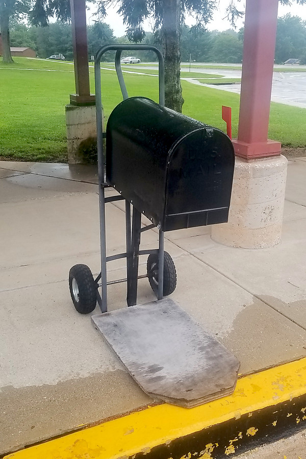 this elementary school has a mobile mailbox attached to a dolly