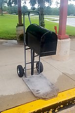 this elementary school has a mobile mailbox attached to a dolly