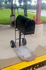 this elementary school has a mobile mailbox attached to a dolly