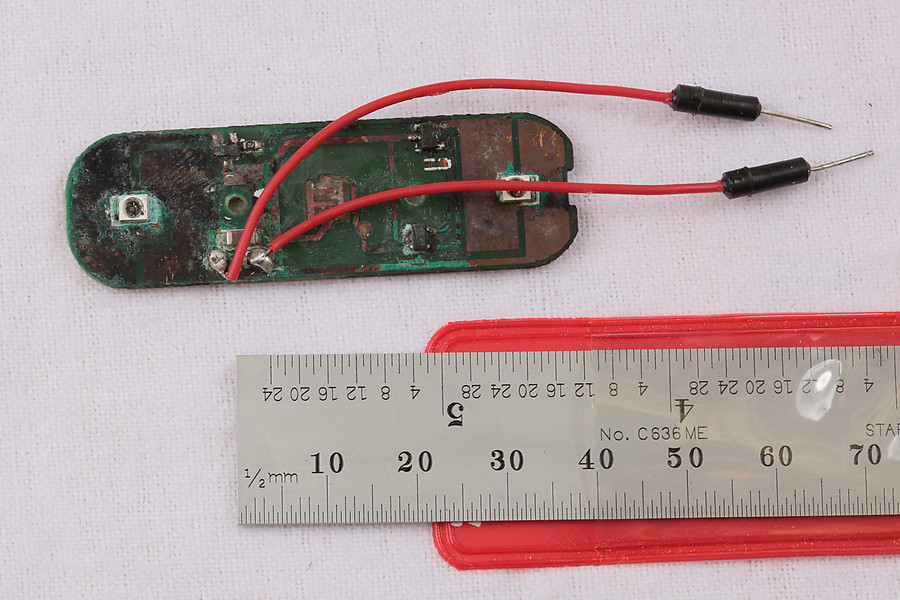 massively corroded bike light (with jumper wires I added on to see if anything was still alive)